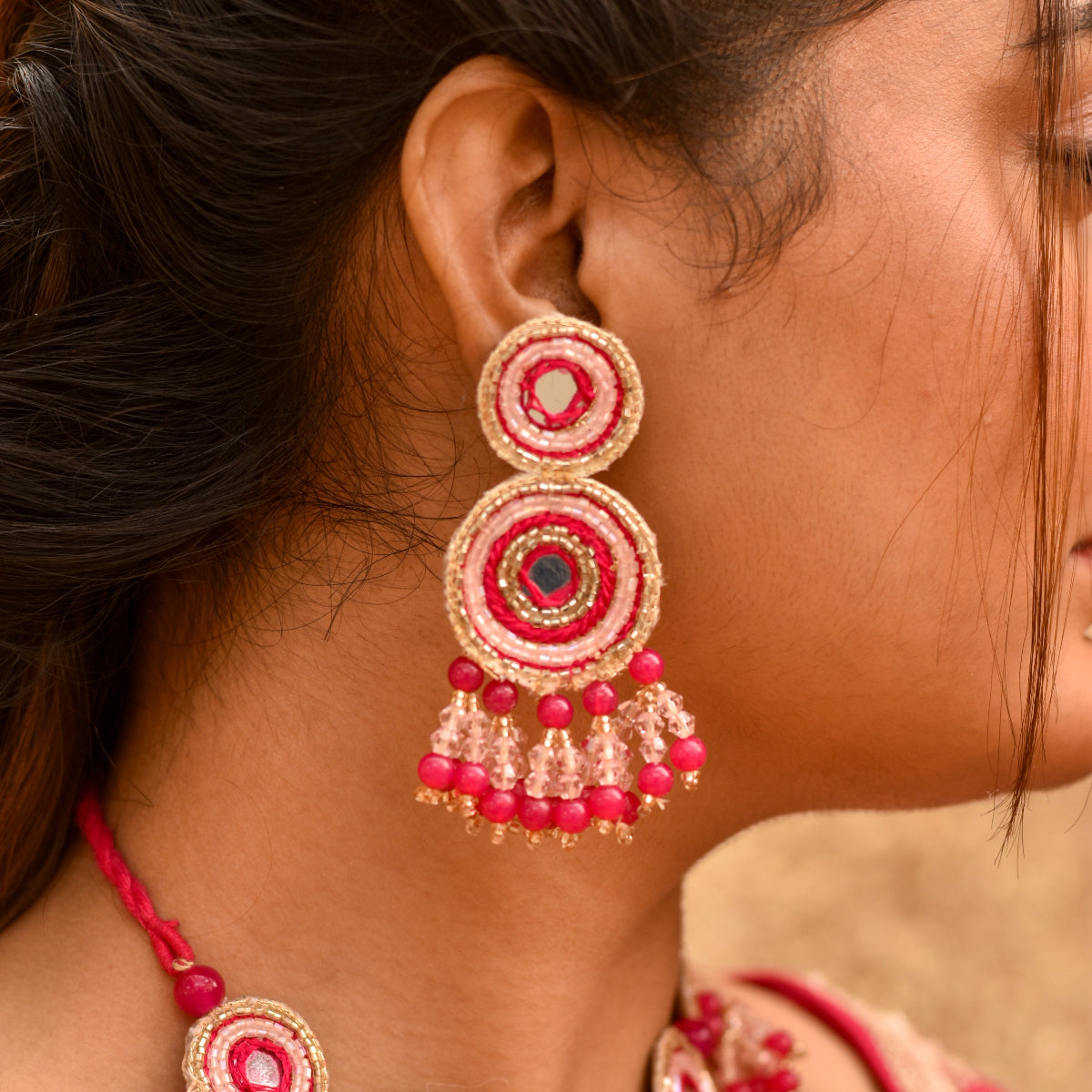 Pink earrings made of glass beads and mirrors for a vibrant haldi look
