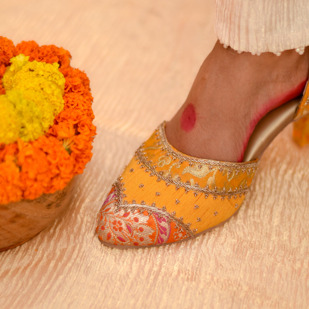 Embroidered orange shoe with floral patterns and zardozi highlights