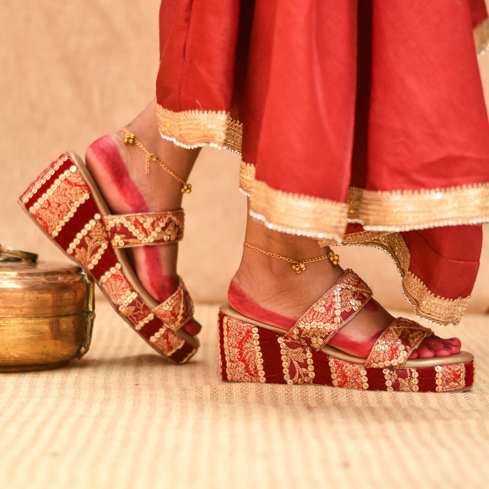 Red wedge sandal with gold woven detailing and double straps
