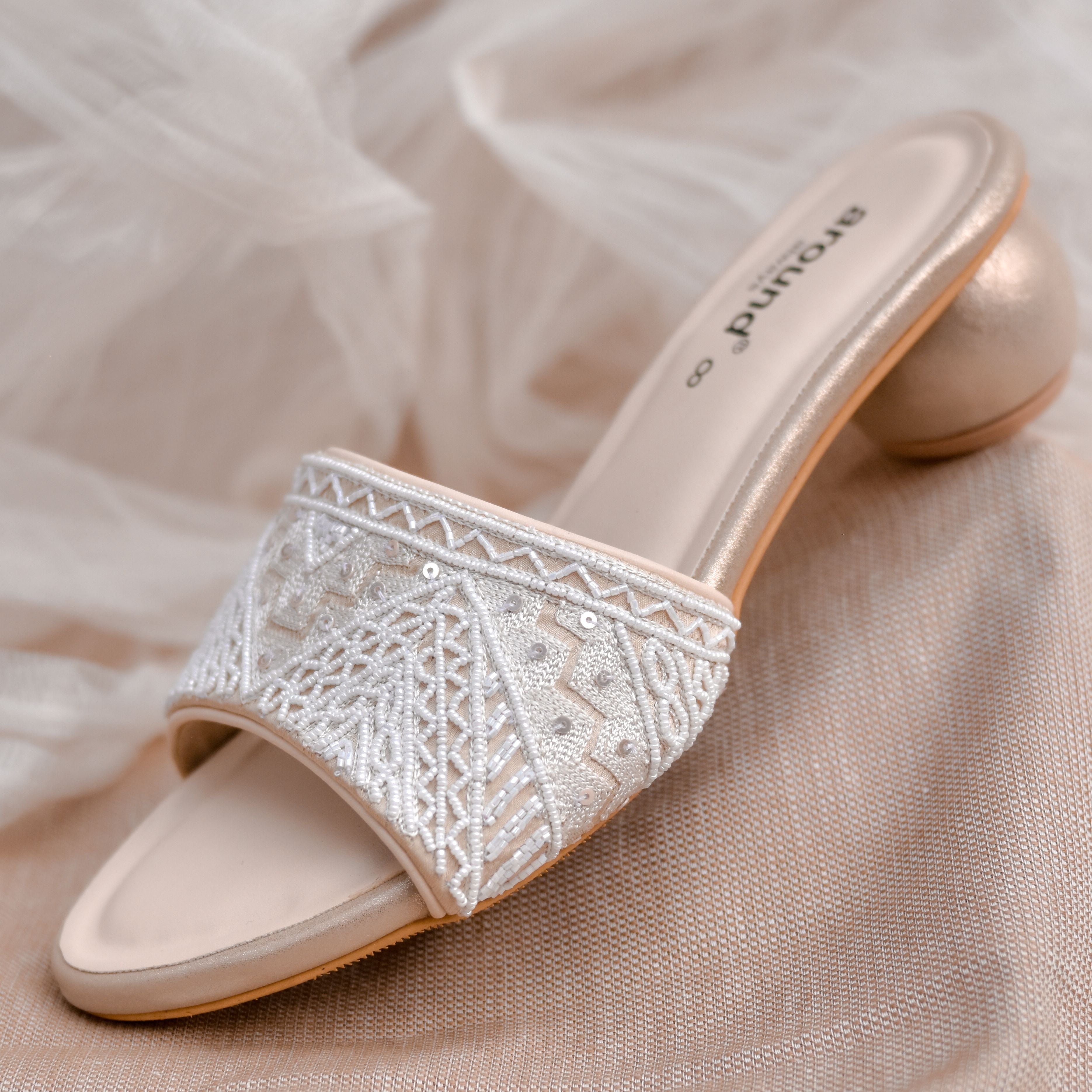 Stylish white wedding heels with hand embellishment