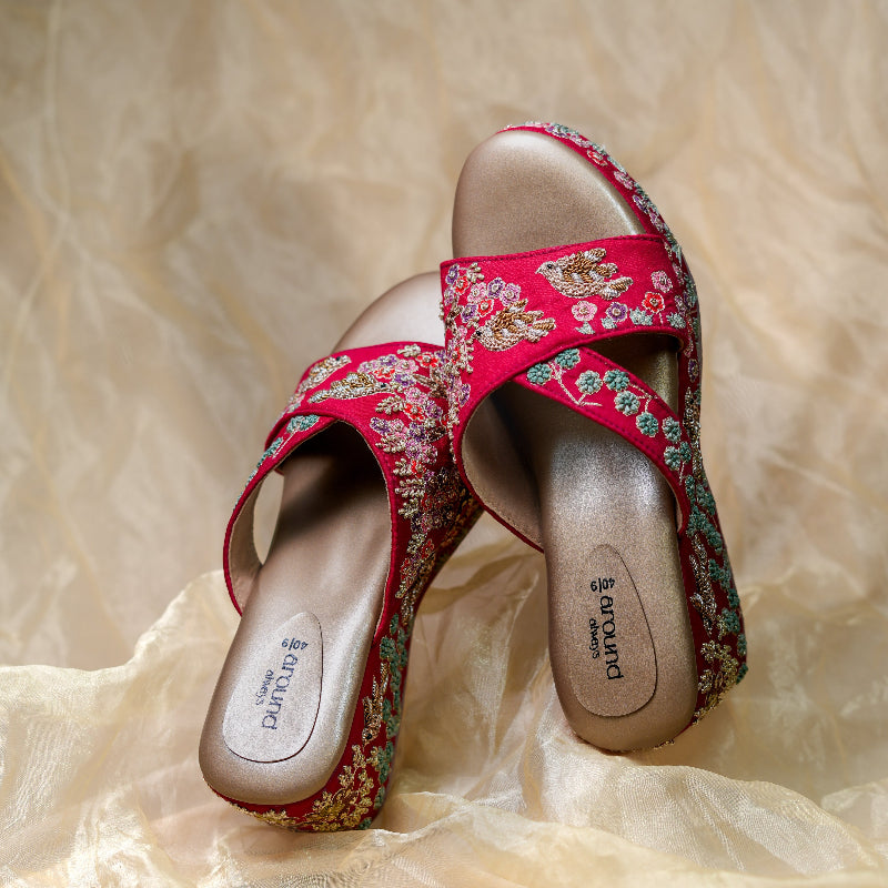 Embroidered wedge heels in reddish maroon with pastel flowers and cushioned footbed
