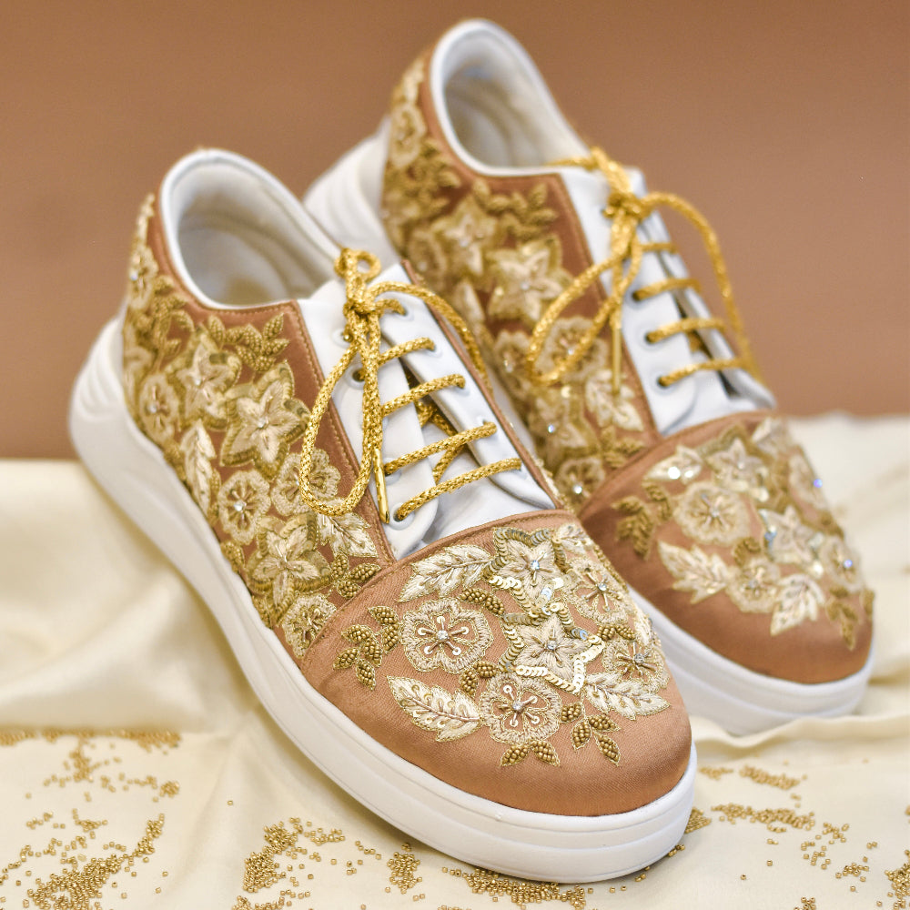 Golden embroidered sneakers with gold lace and floral detailing