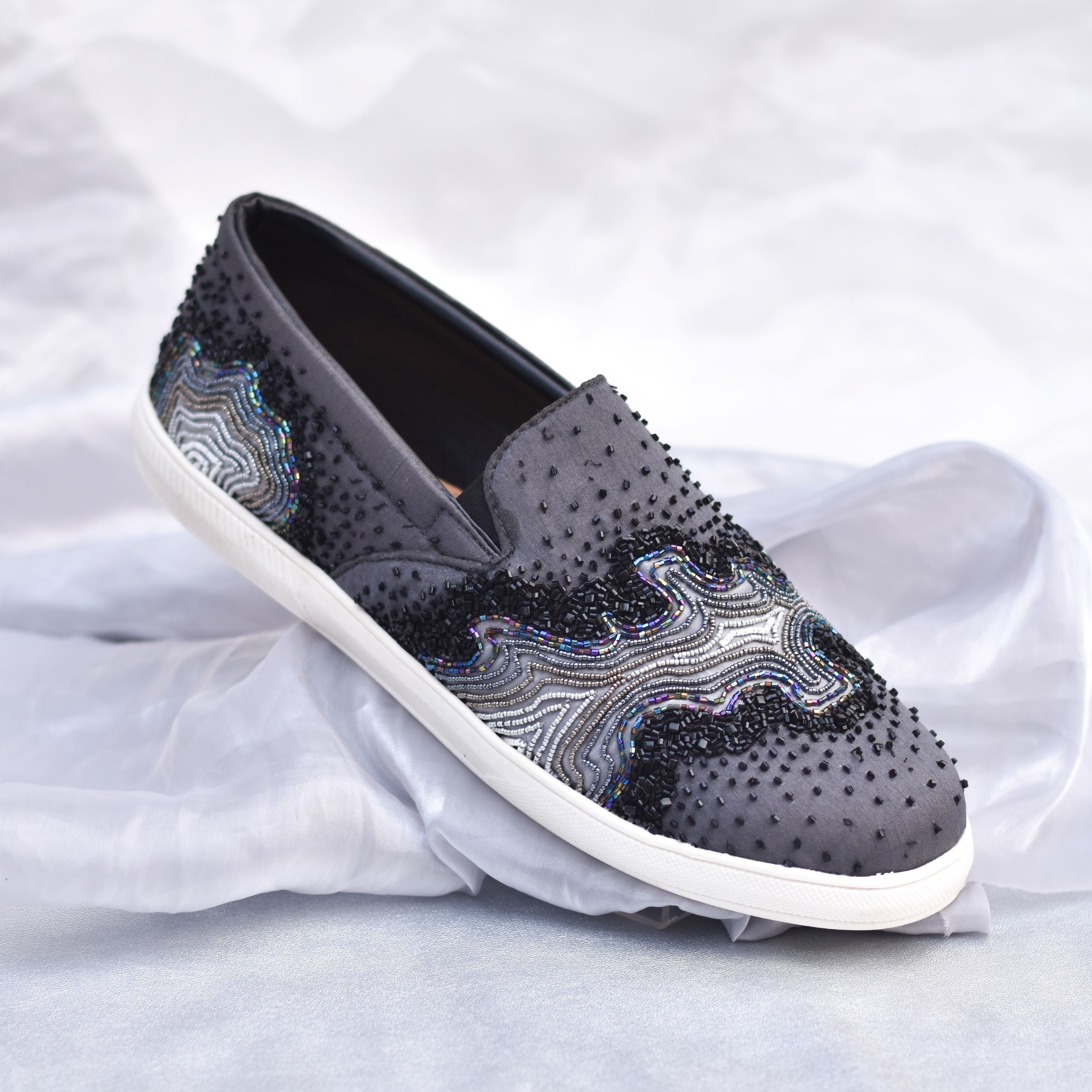 Matte grey party sneakers with metallic bead detailing and black dotted embellishments.