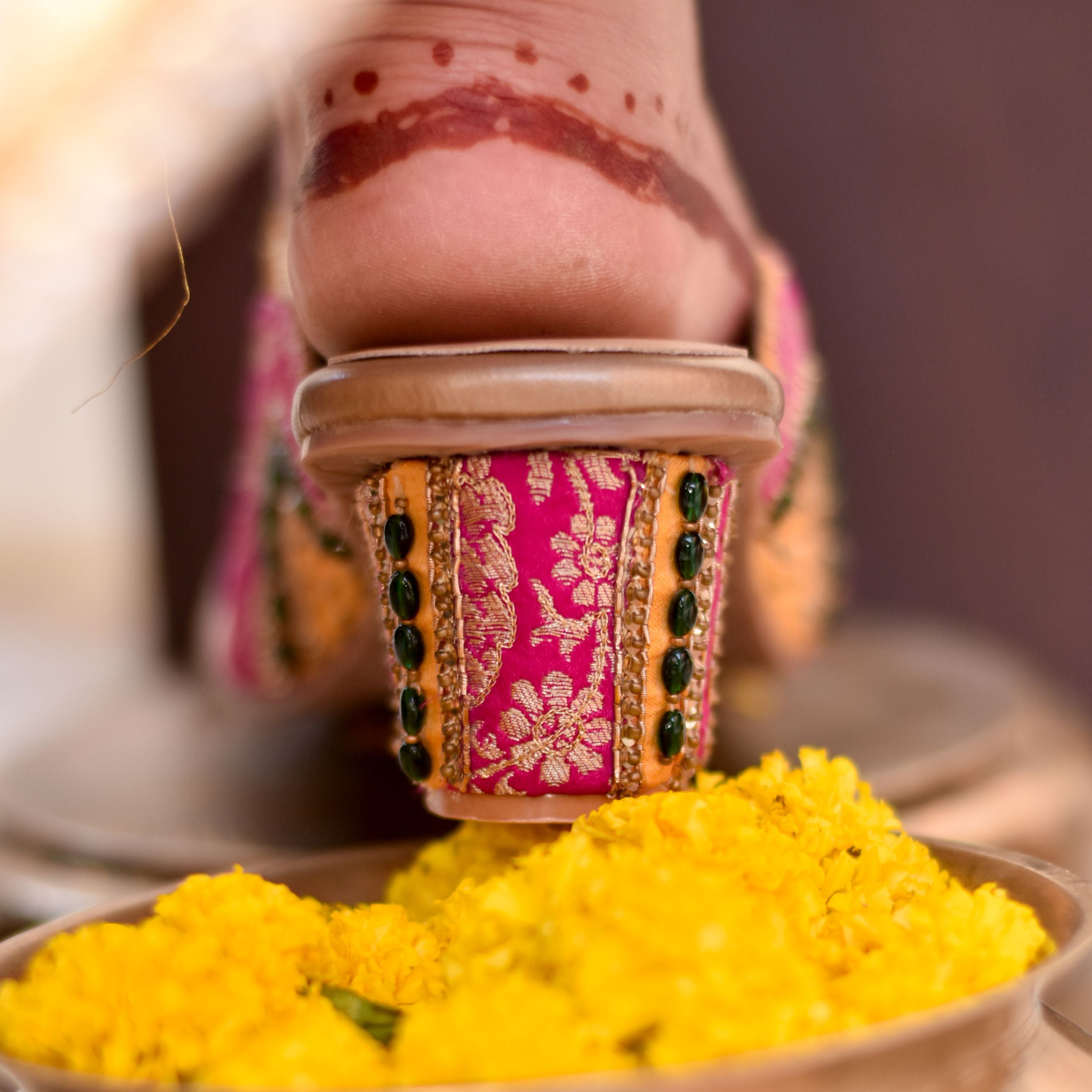 Festive women’s heels with pink and yellow fabric and green beads
