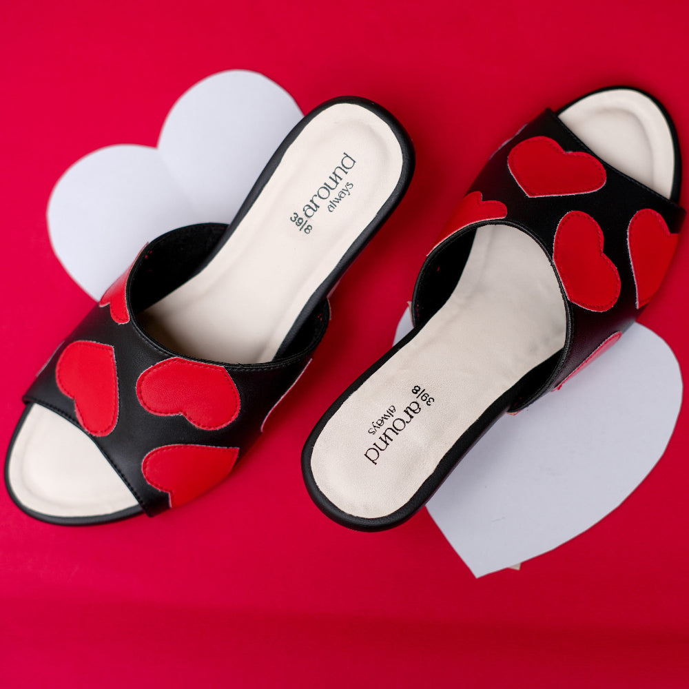 Black open-toe heeled sandal featuring multiple red hearts
