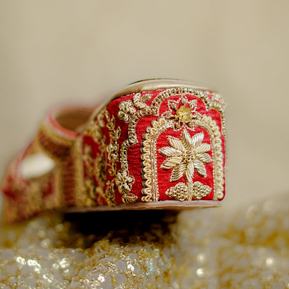 Red festive wedges with gold decorative elements and a soft footbed.