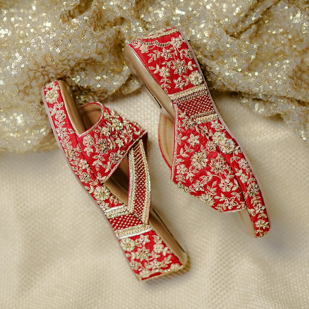 Festive red wedges with intricate gold accents and supportive cushioning.