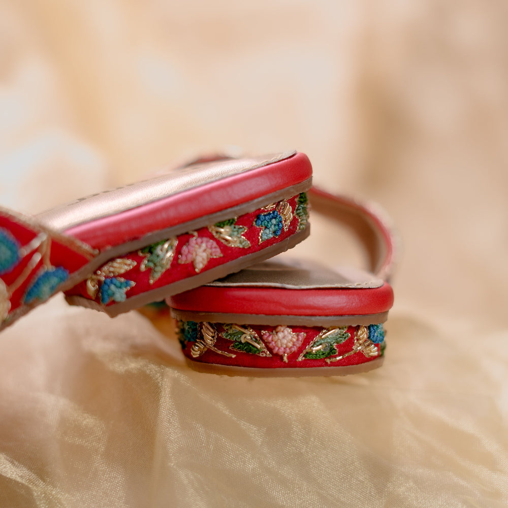 Festive red flats with blue green and pink floral detailing and cushioned footbed

