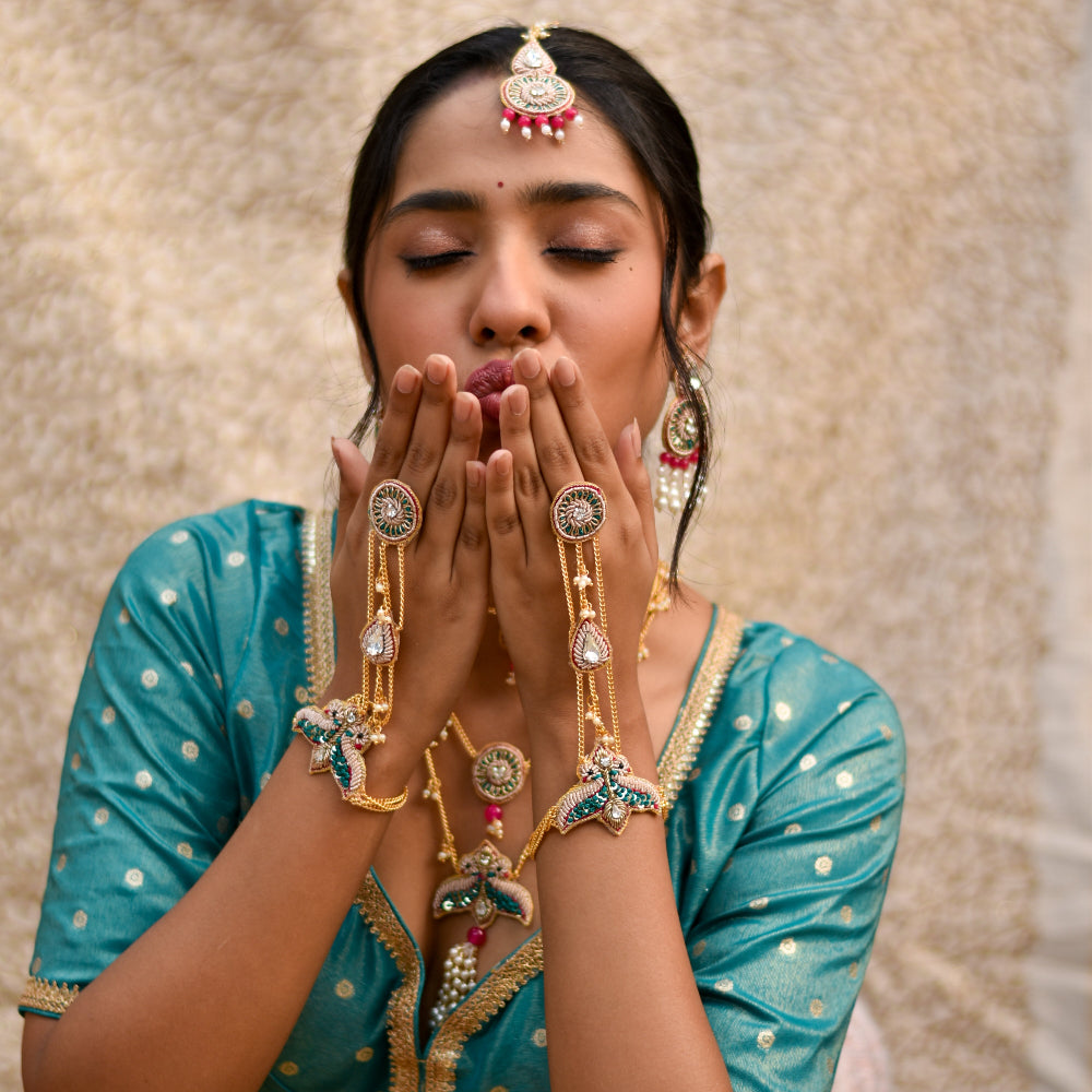 Trendy haldi accessories with intricate hathphool, neckpiece and maangtika 