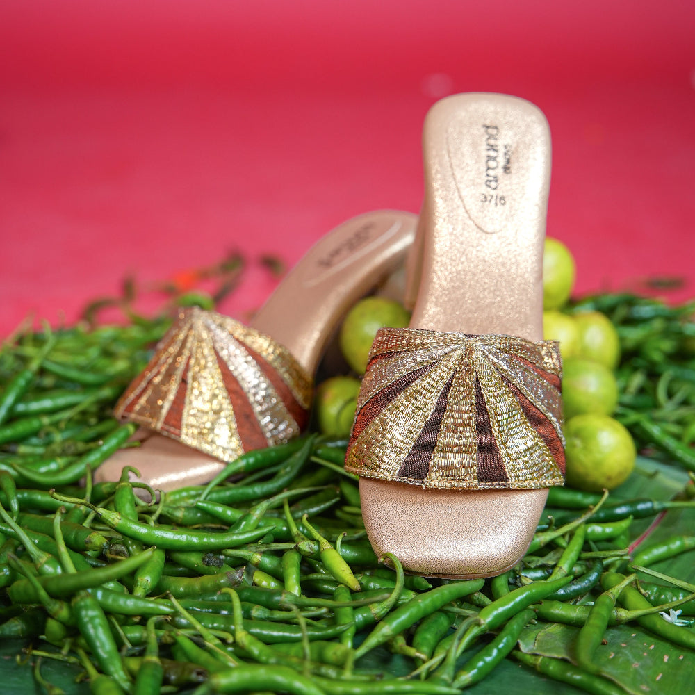 Festive champagne footwear featuring a sunburst-inspired metallic pattern
