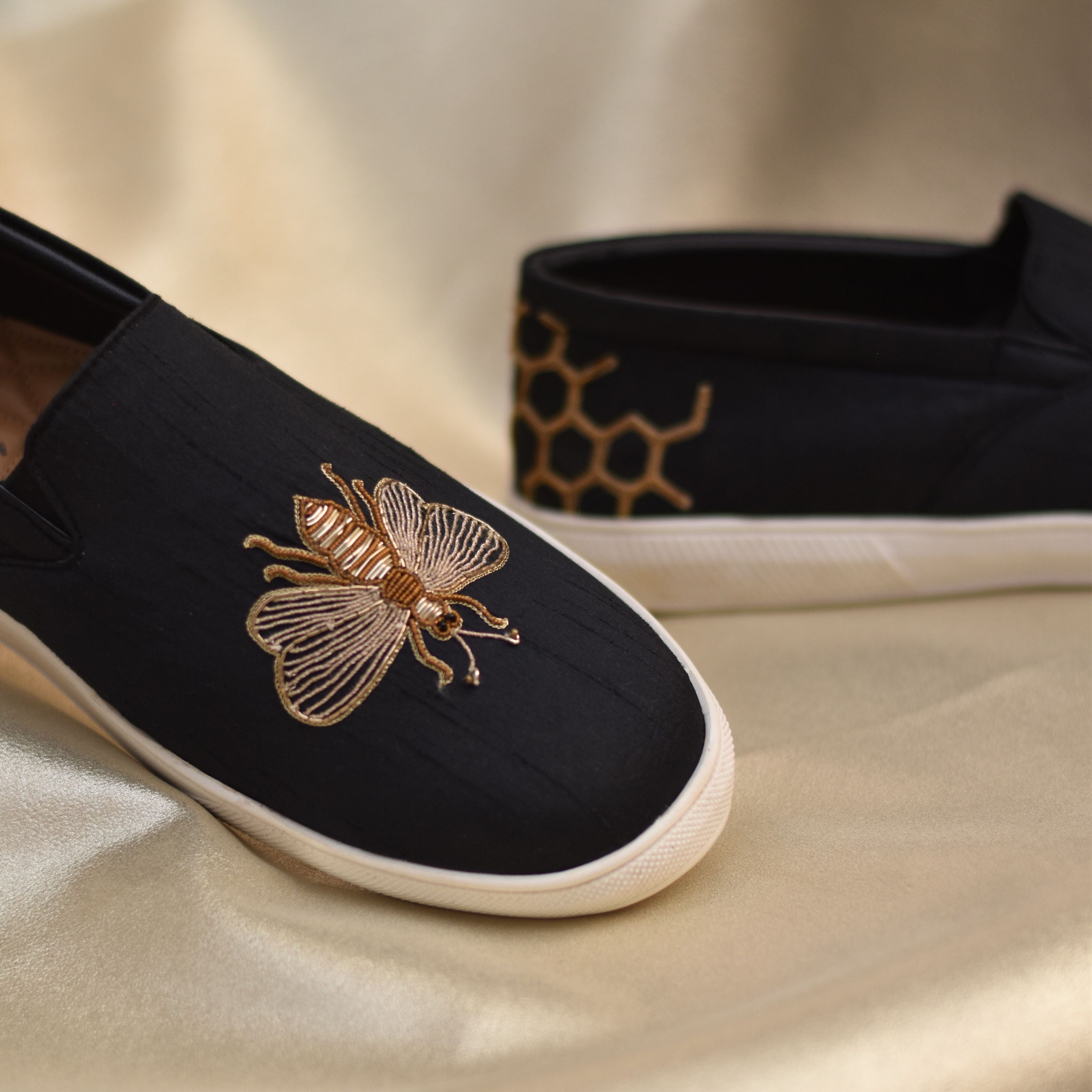 Stylish wedding pair showcasing textured threadwork and zardozi embroidery.