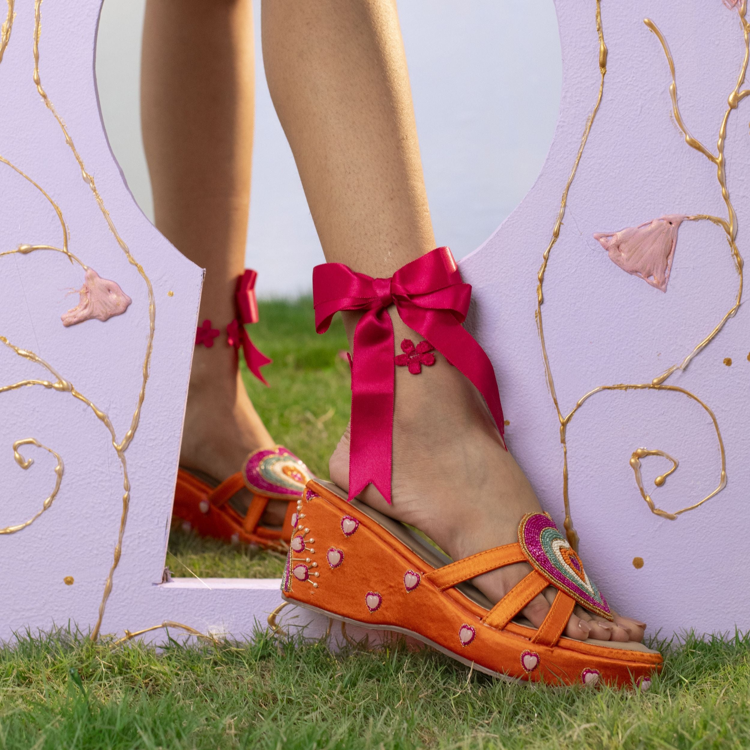 Designer sandals with heart motif and embroidered platform