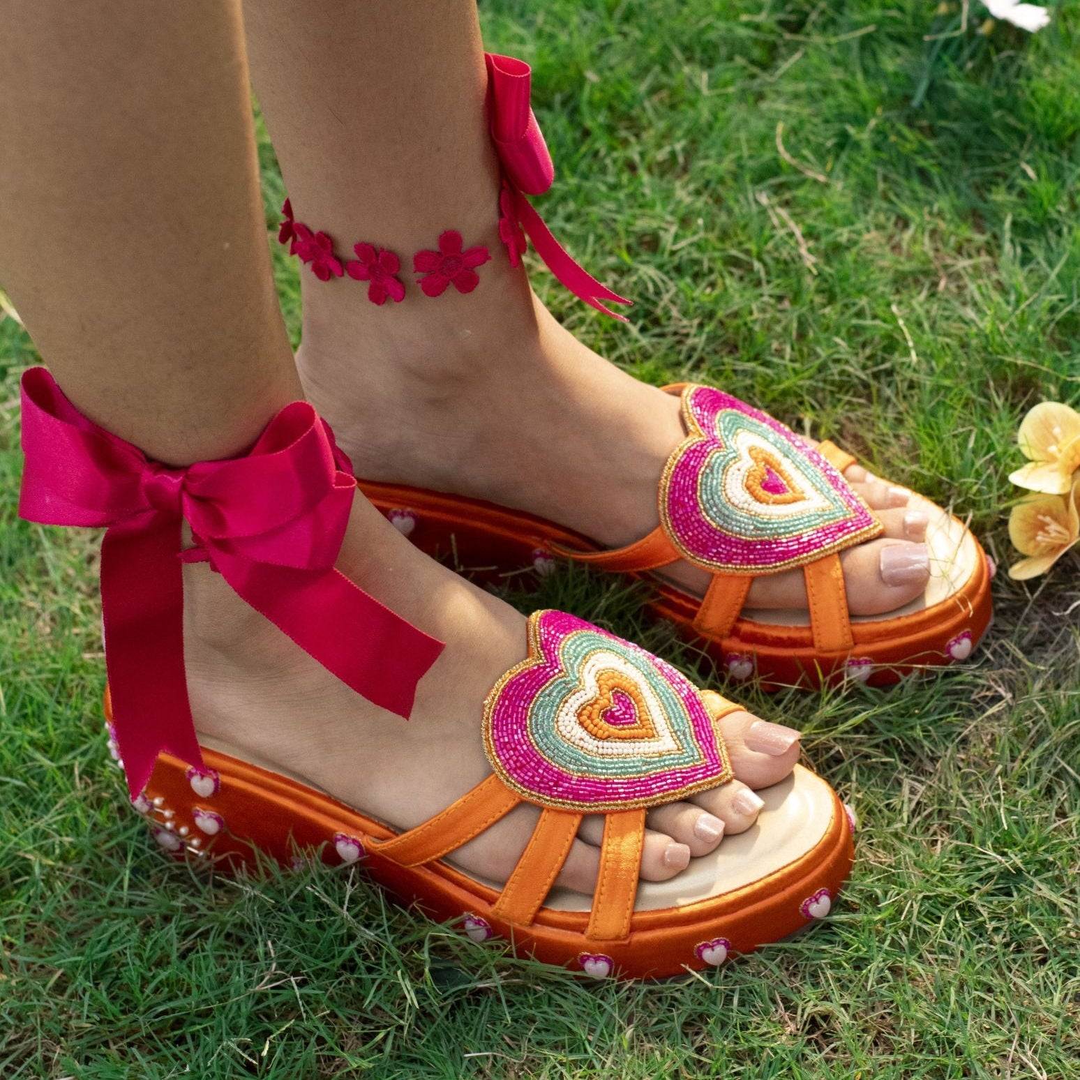 Orange flatform sandals with multicolour heart embellishment