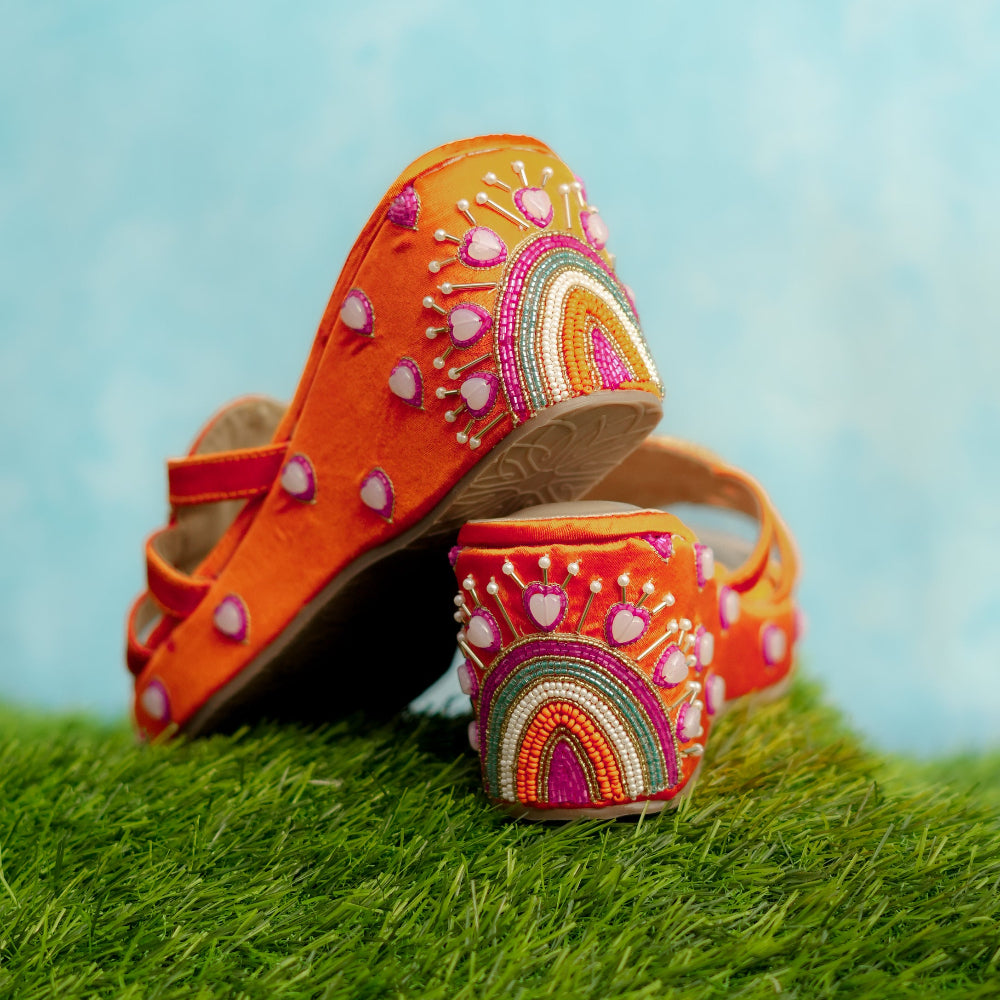 Pop colour wedges  with embroidered on a grassy surface with a blue sky background