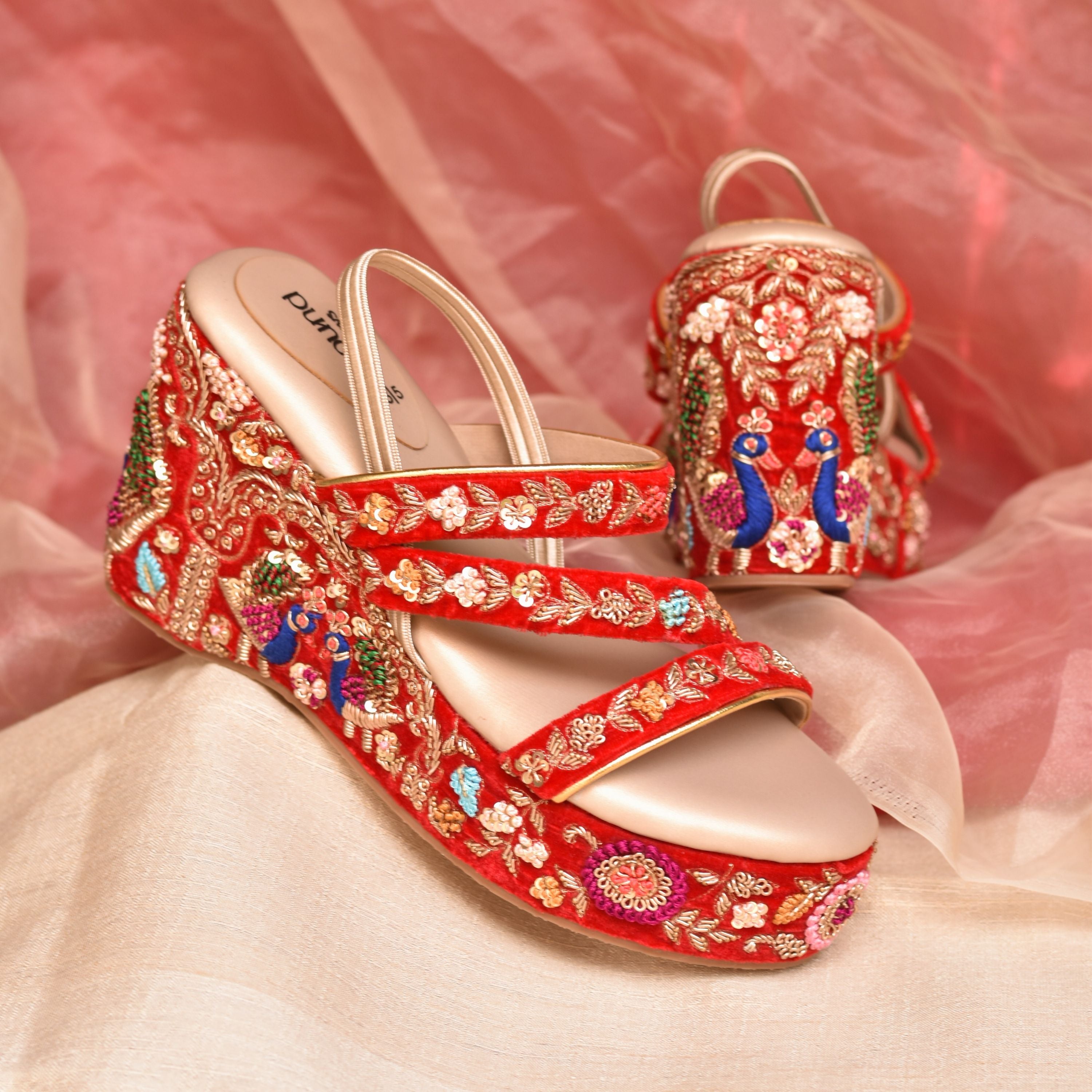 Red bridal wedge heels with colourful peacock and floral hand embroidery.