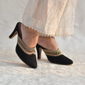 Black pencil heel mules with gold zardozi work worn with a tissue sharara pants