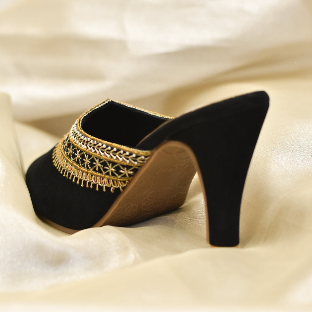 Handcrafted black velvet mules with sleek high heel and comfort sole.