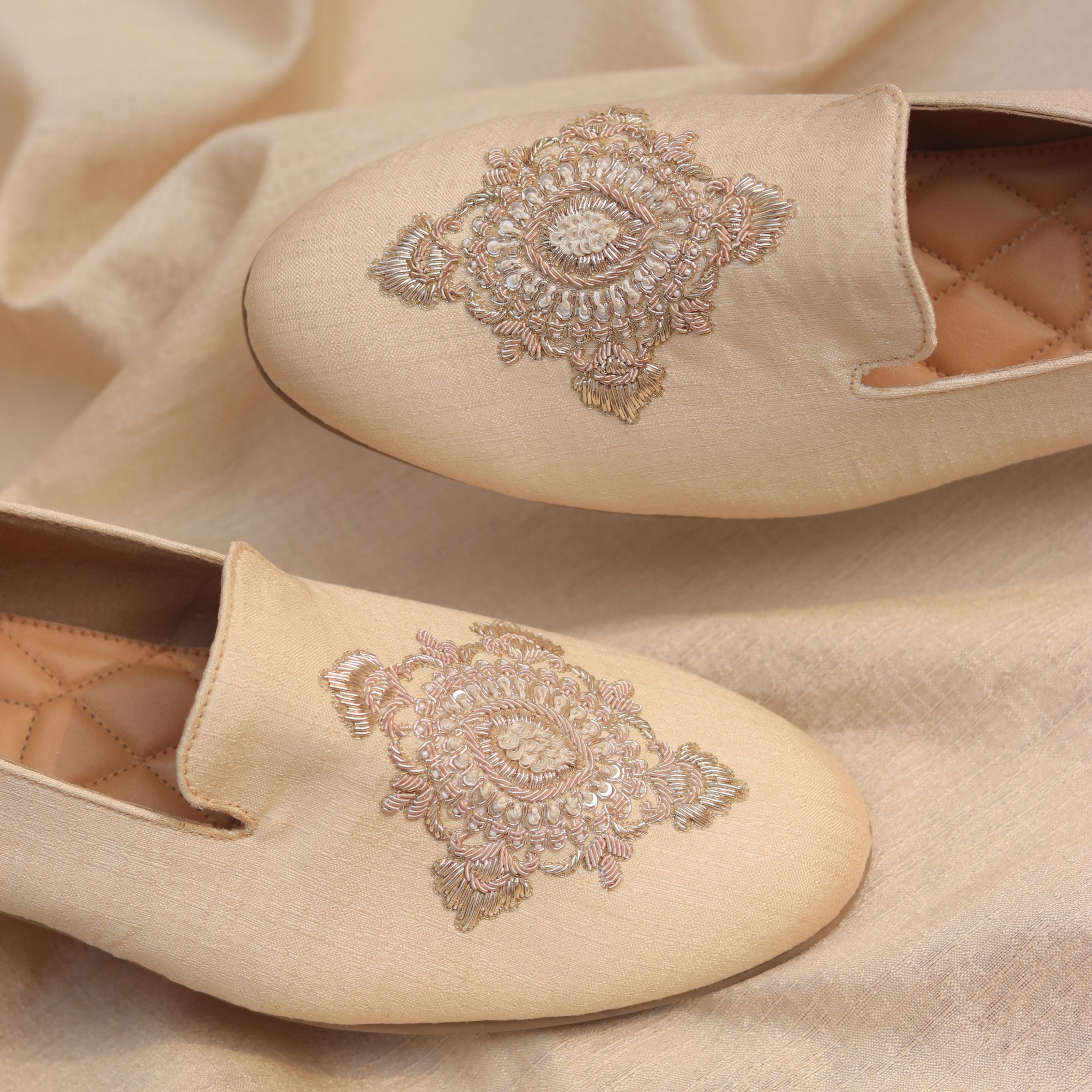 Elegant footwear featuring light gold, ivory threadwork with hints of pearls and cushioned insole