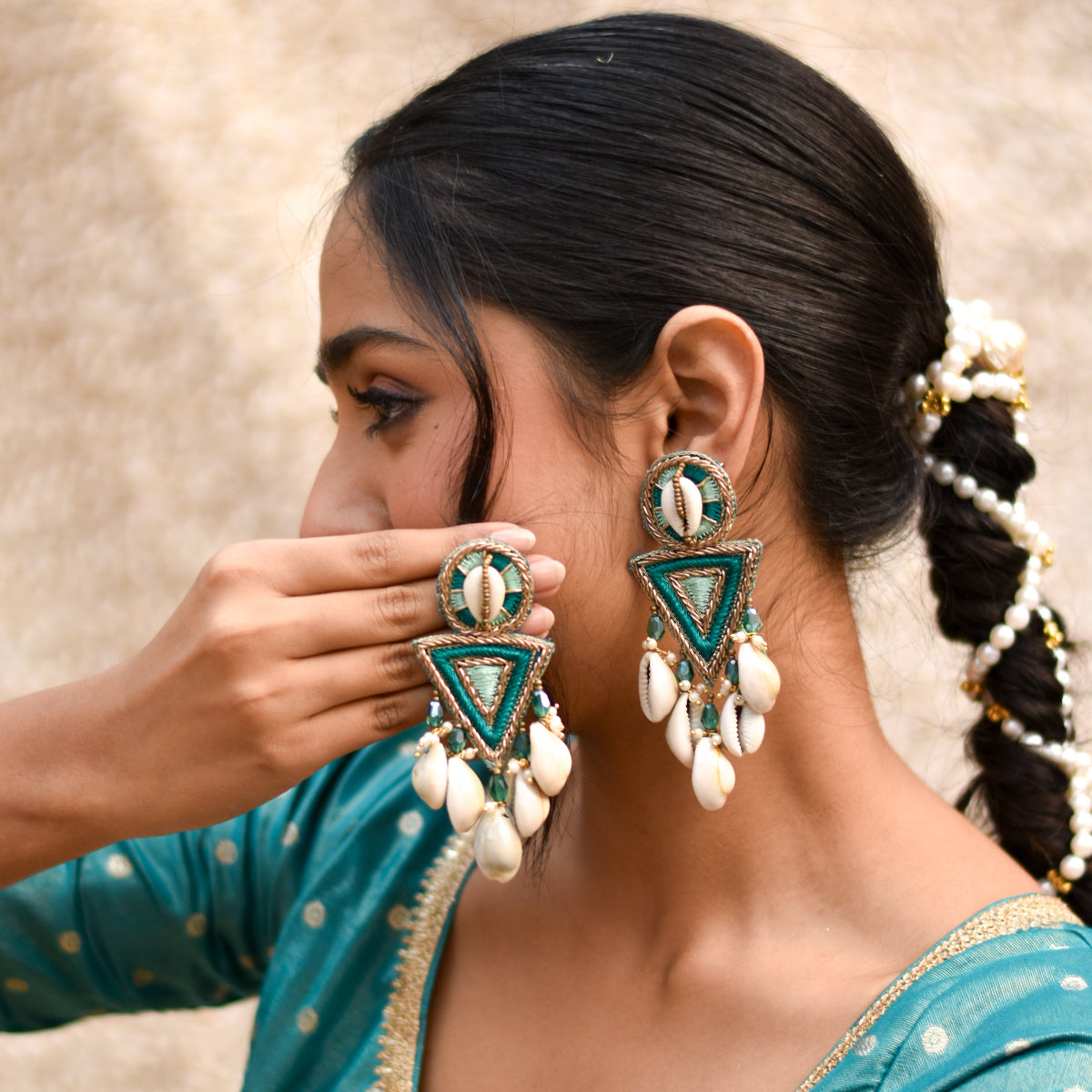 Teal handmade earrings with cowrie shell drops and gold detailing