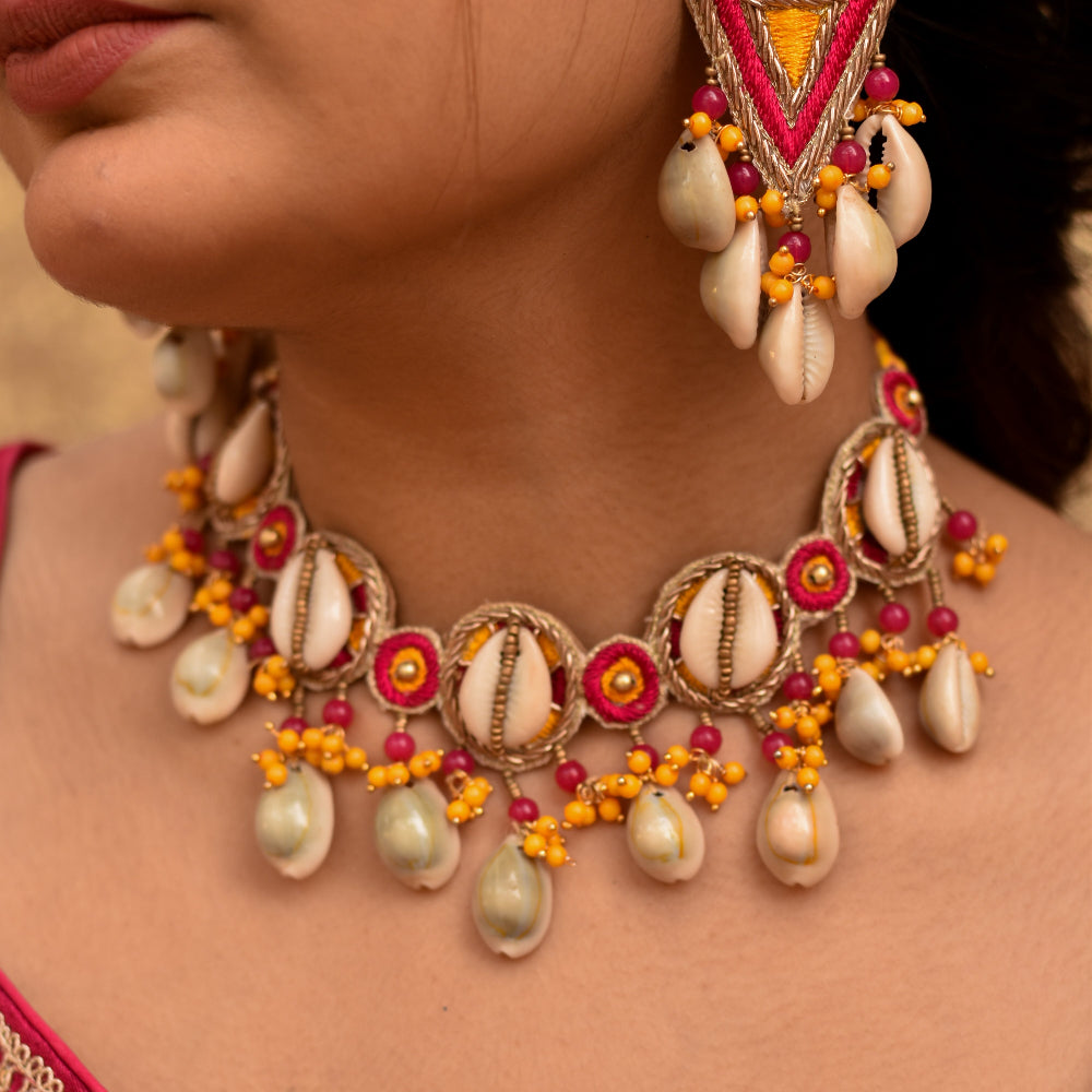 Festive pink and yellow choker necklace with cowrie shells and bead danglers