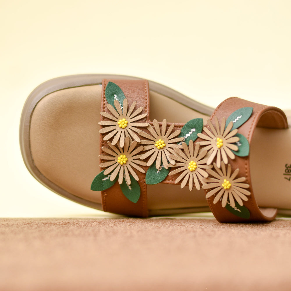Women's caramel slide featuring three-dimensional floral design