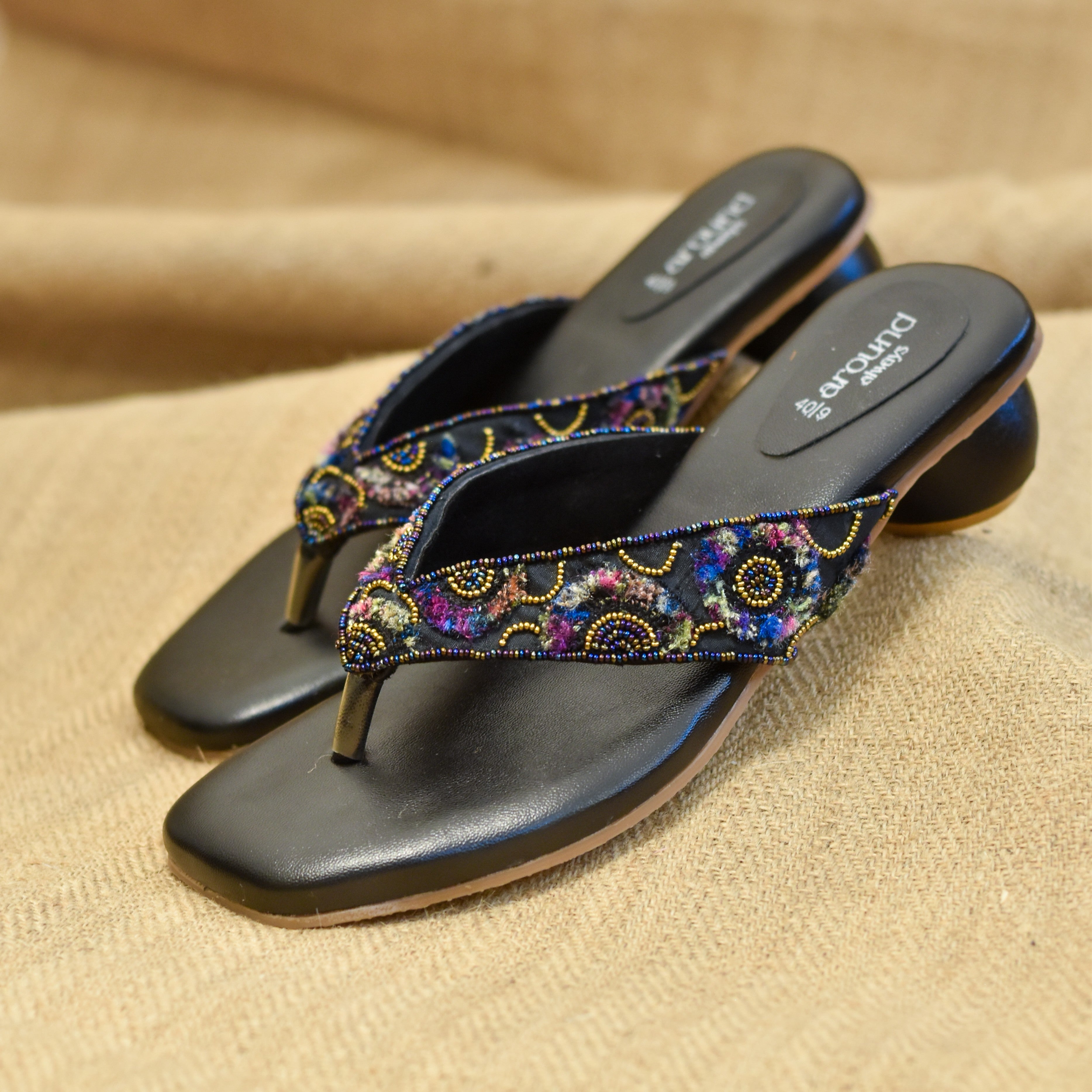 Black base slides with playful yarn textures and tiny bead highlights