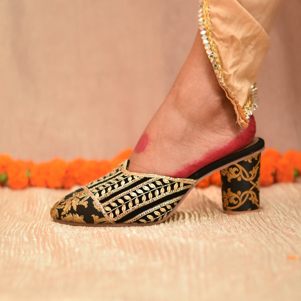 Ethnic mule heel with detailed gold motifs on black base and cushioned footbed