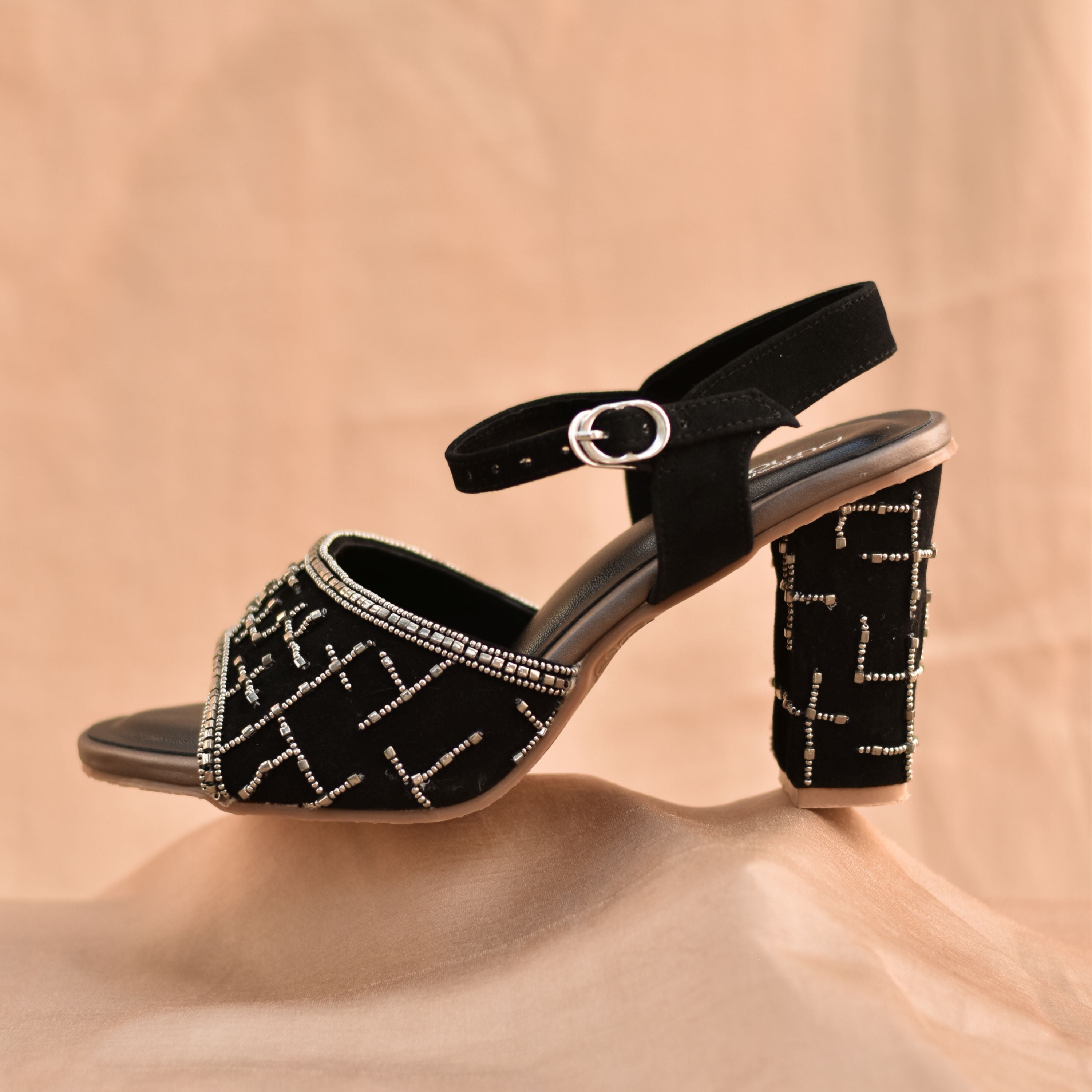 Party wear black heels with silver hand-beaded design.
