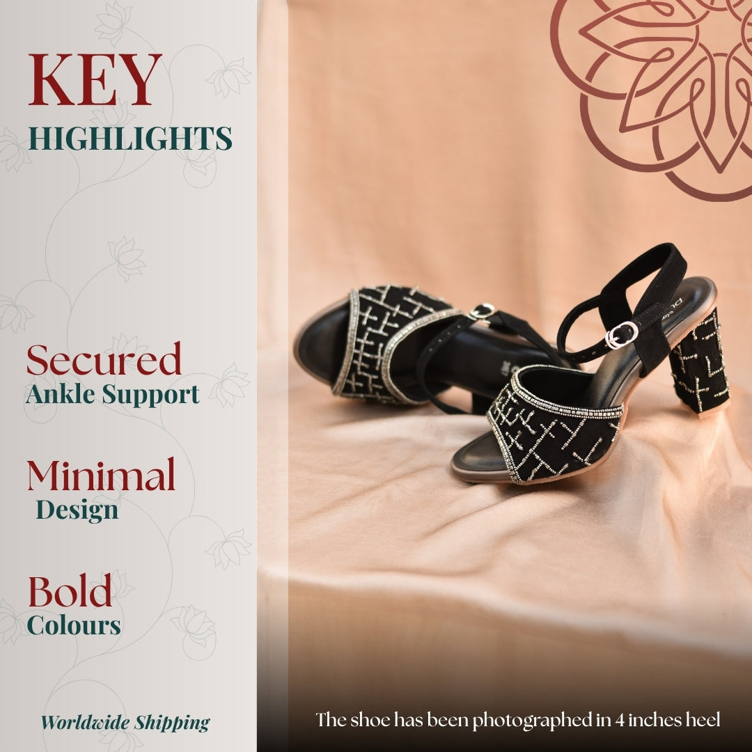 Black ankle strap heels with geometric silver embellishments and a sturdy block heel