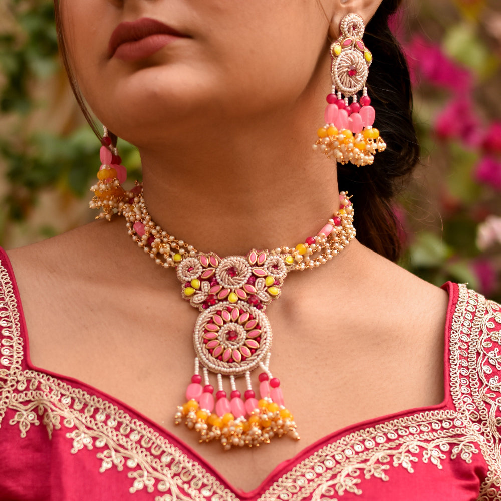 Indian bride wearing a handmade pink and gold necklace and earrings for her haldi look