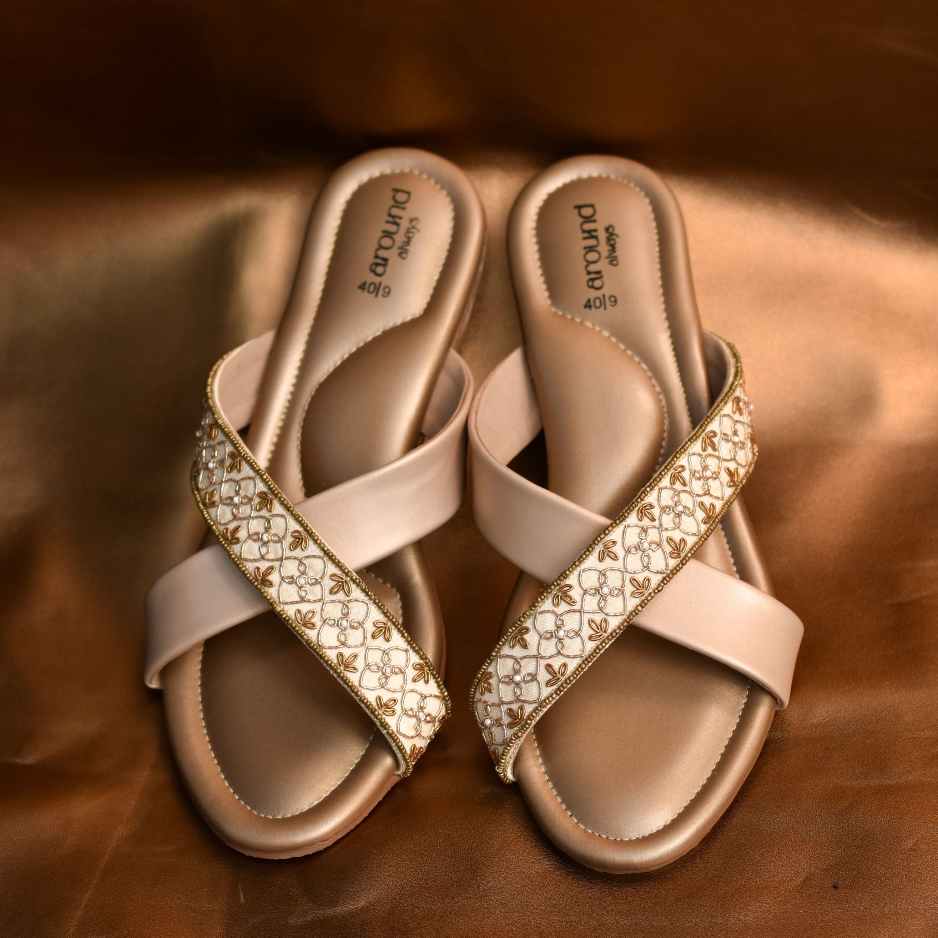 Designer slip-on sandals with cushioned sole and festive detailing.