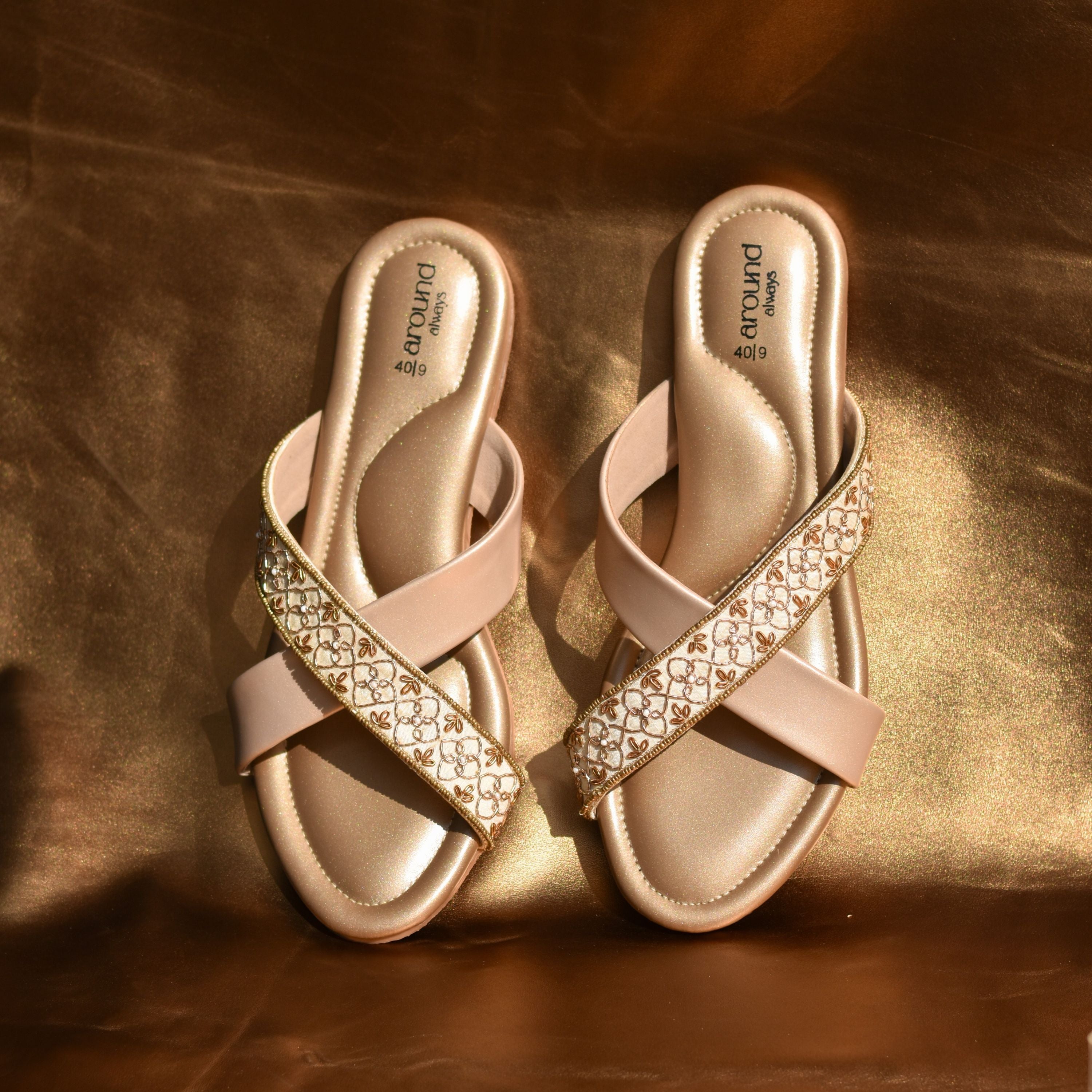 Festive crossover sandals in nude-gold with hand-stitched embroidery.