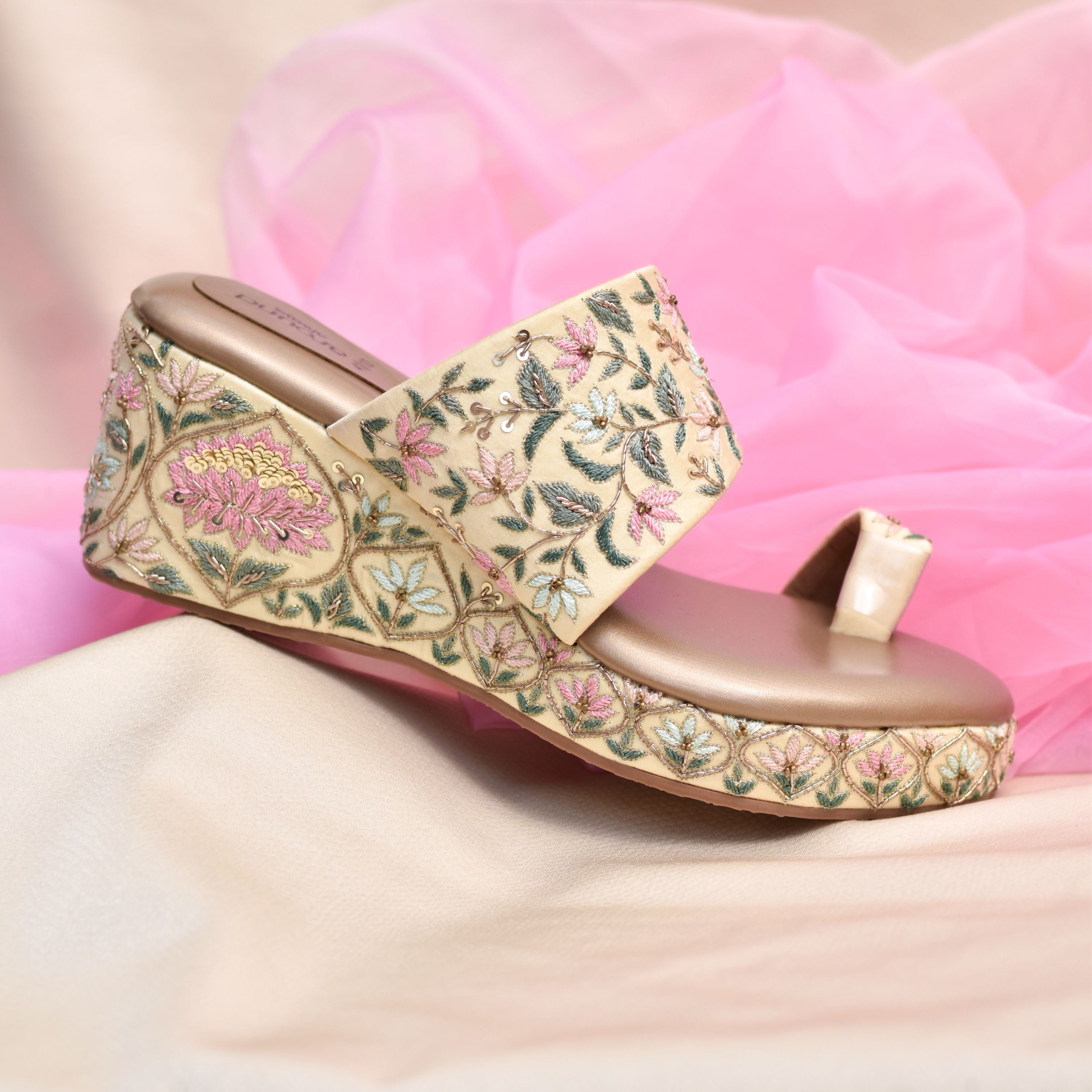 Designer wedge kolhapuri with pink, green, and teal floral detailing.