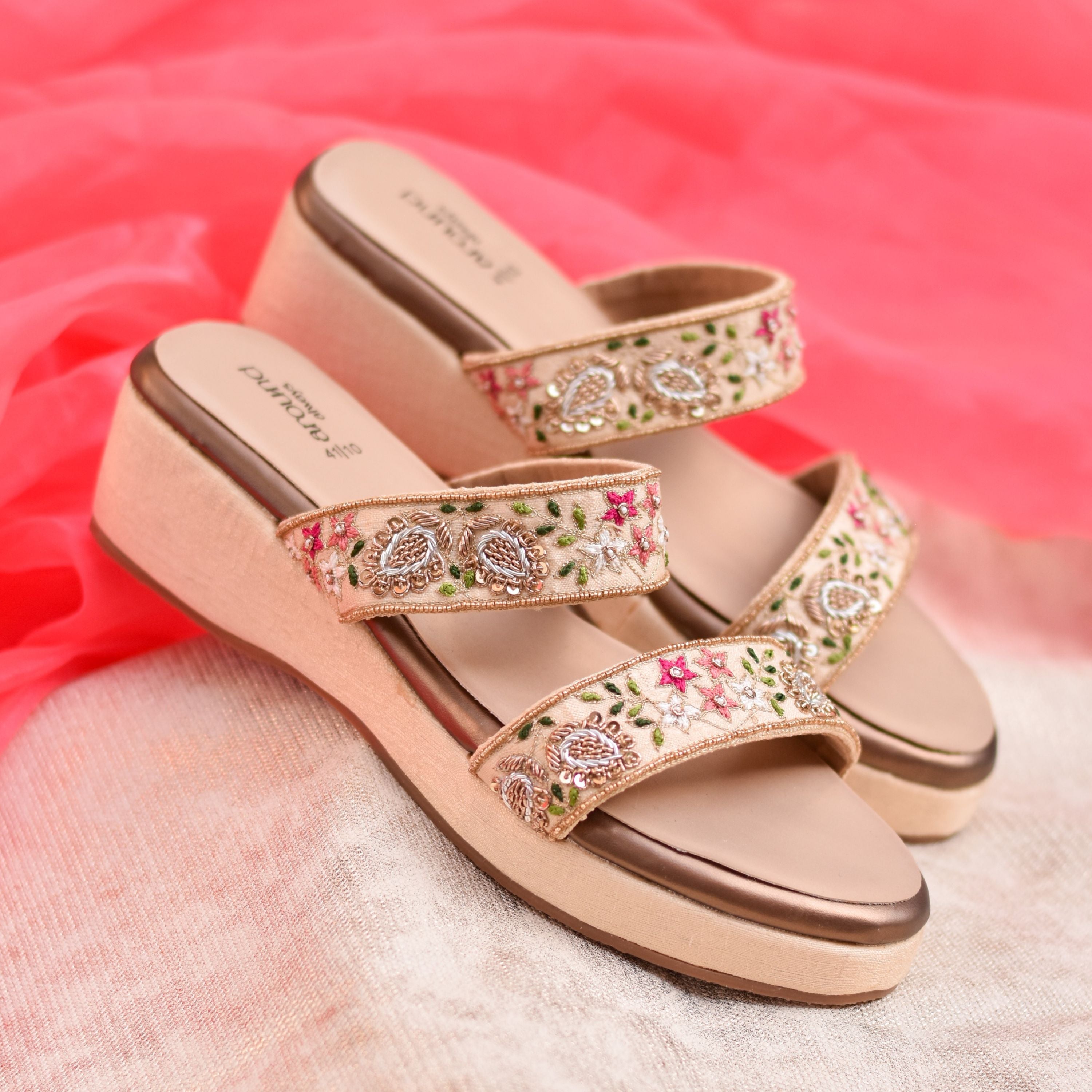 Gold-toned wedge with multicolour floral thread details and subtle shine