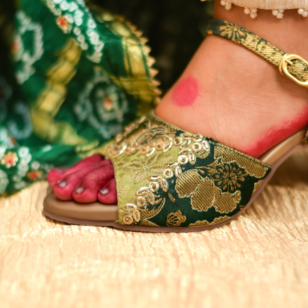 Close-up of green and gold occasion heel with sequins detailing and antiskid insole.