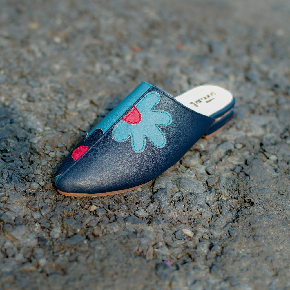Navy blue mule with oversized floral appliqué and pointed toe
