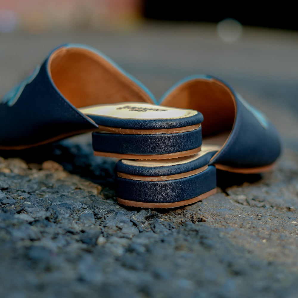 Navy pointed-toe mule with playful flower design and cushioned footbed
