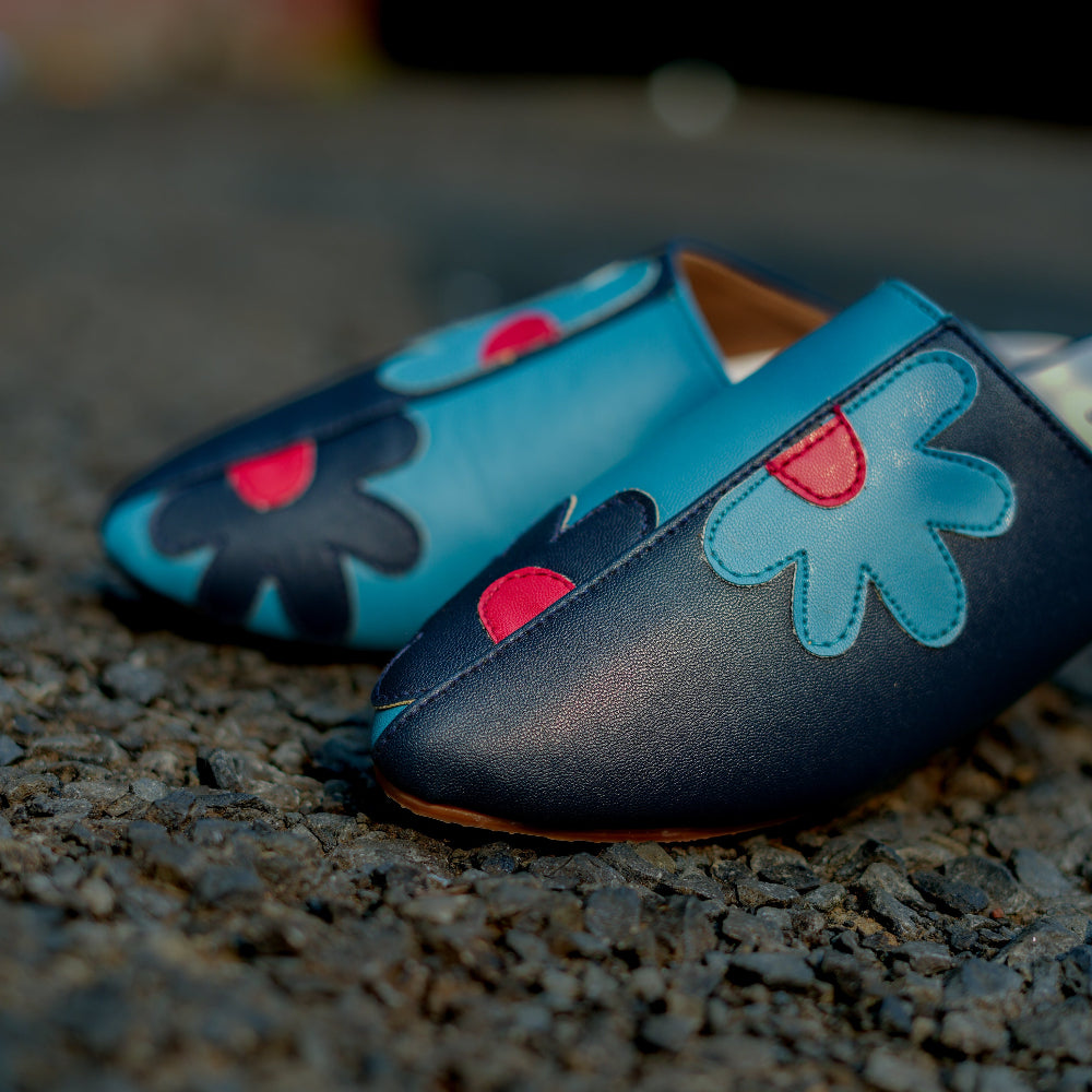 Artistic mule in deep blue with colourful floral detailing
