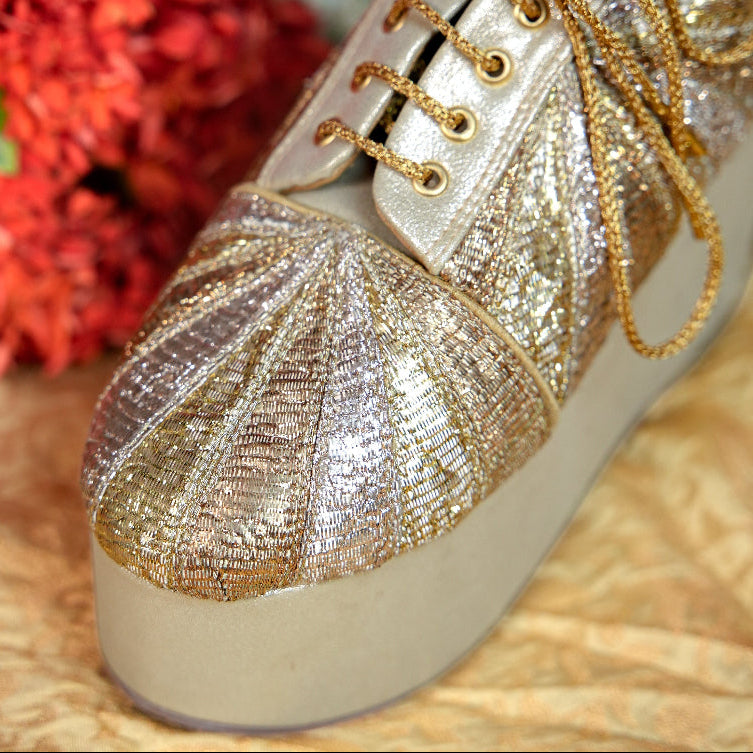 Festive champagne sneaker wedge with woven metallic upper