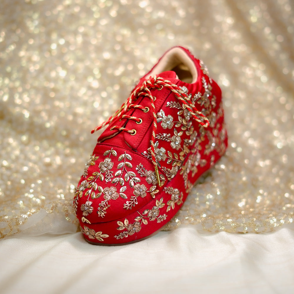 Red bridal sneaker wedge adorned with floral zardozi embroidery and metallic detailing