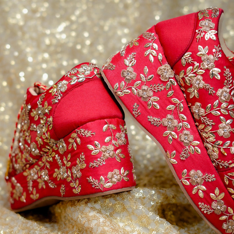 Elevated red sneaker wedge with ornate floral craftsmanship and traditional zardozi work