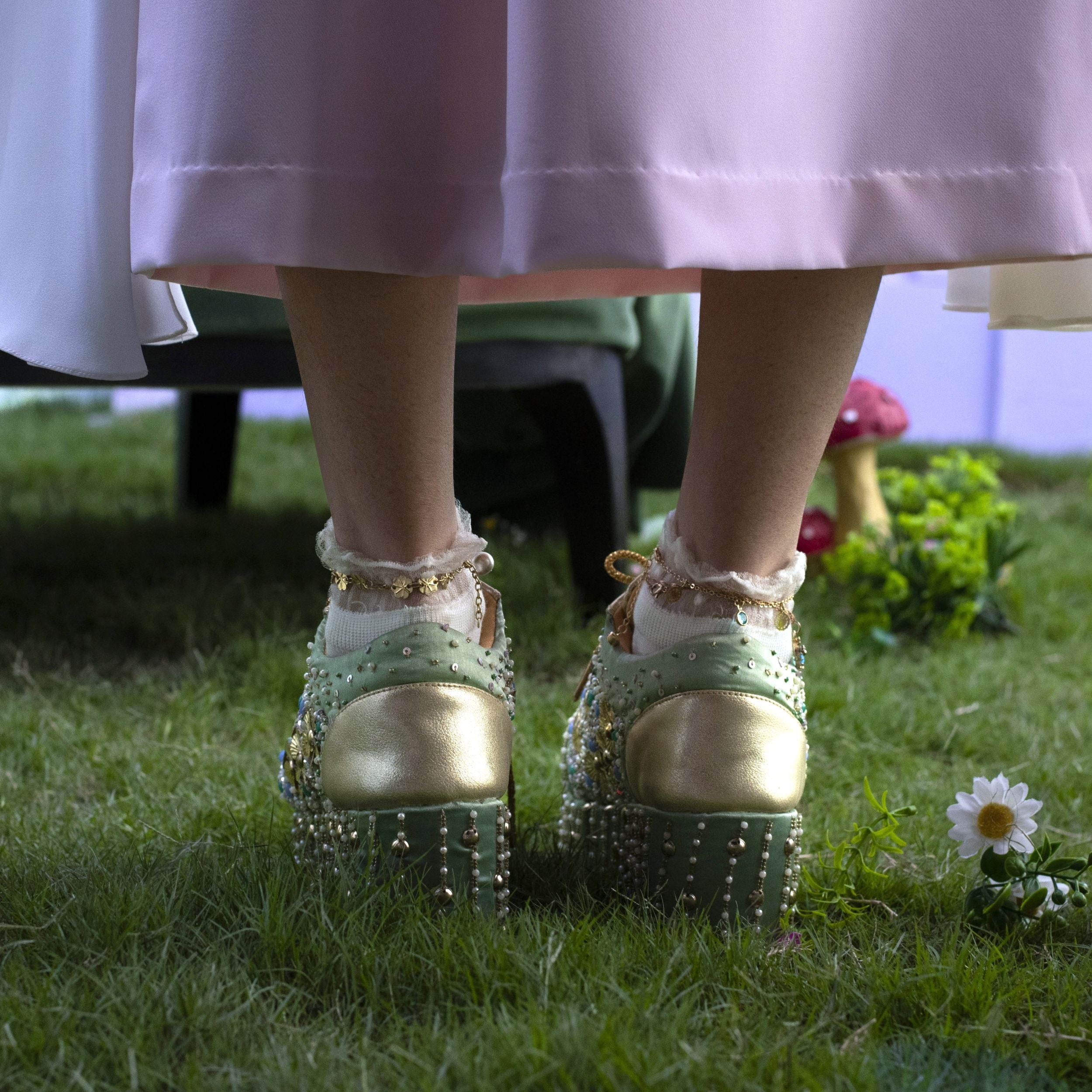 Designer wedge sneakers in green colour with embellished designs and cushioned insole.