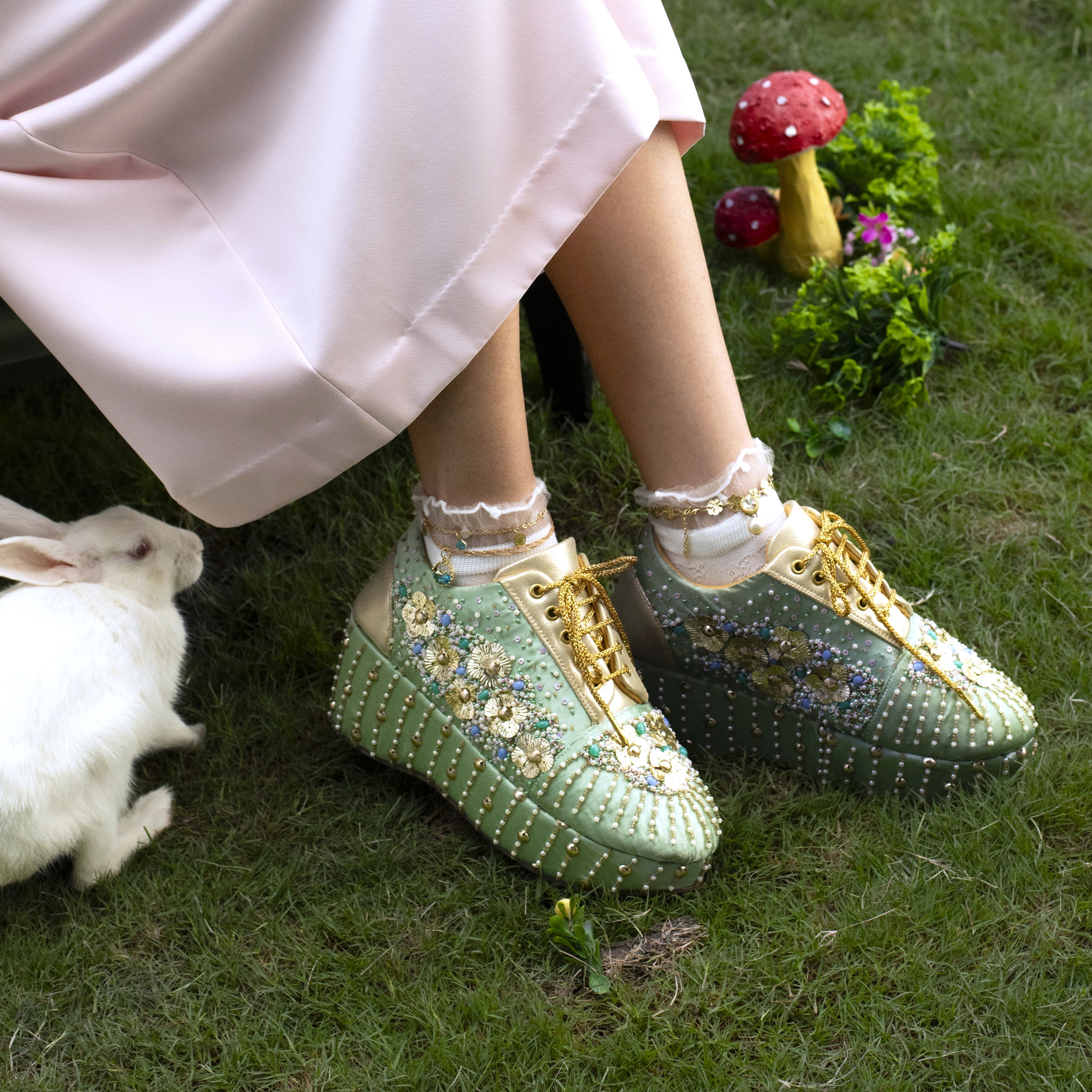 Sea green embellished wedge sneakers with floral bead motifs