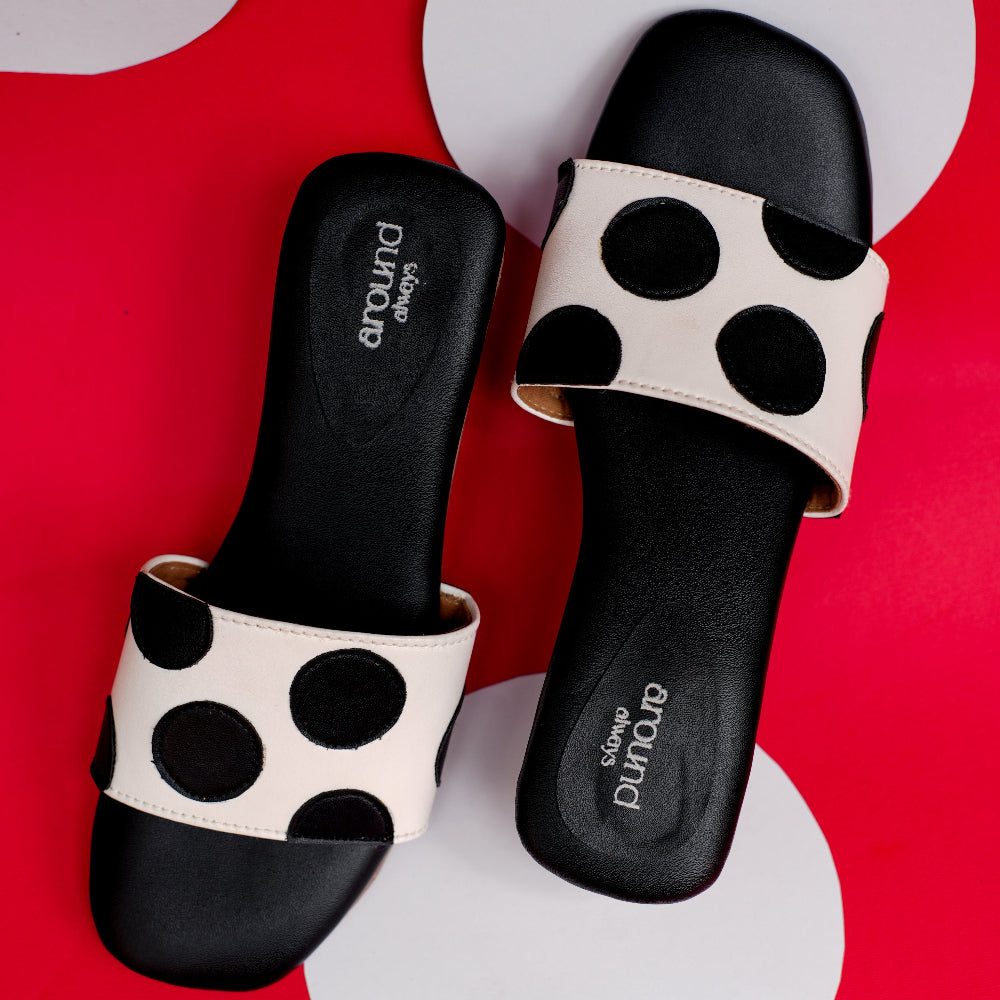 Ivory front strap sandal featuring bold black polka dot motifs
