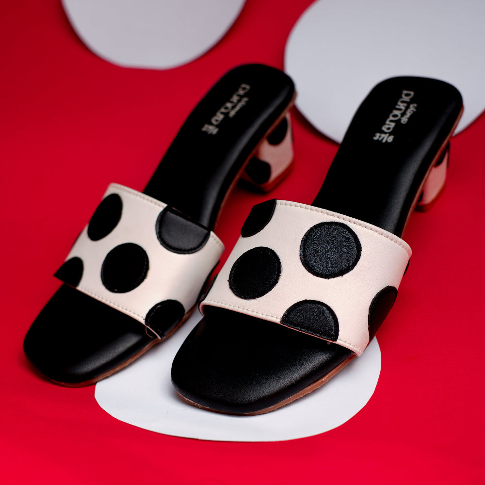 White and black footwear with graphic round appliqués
