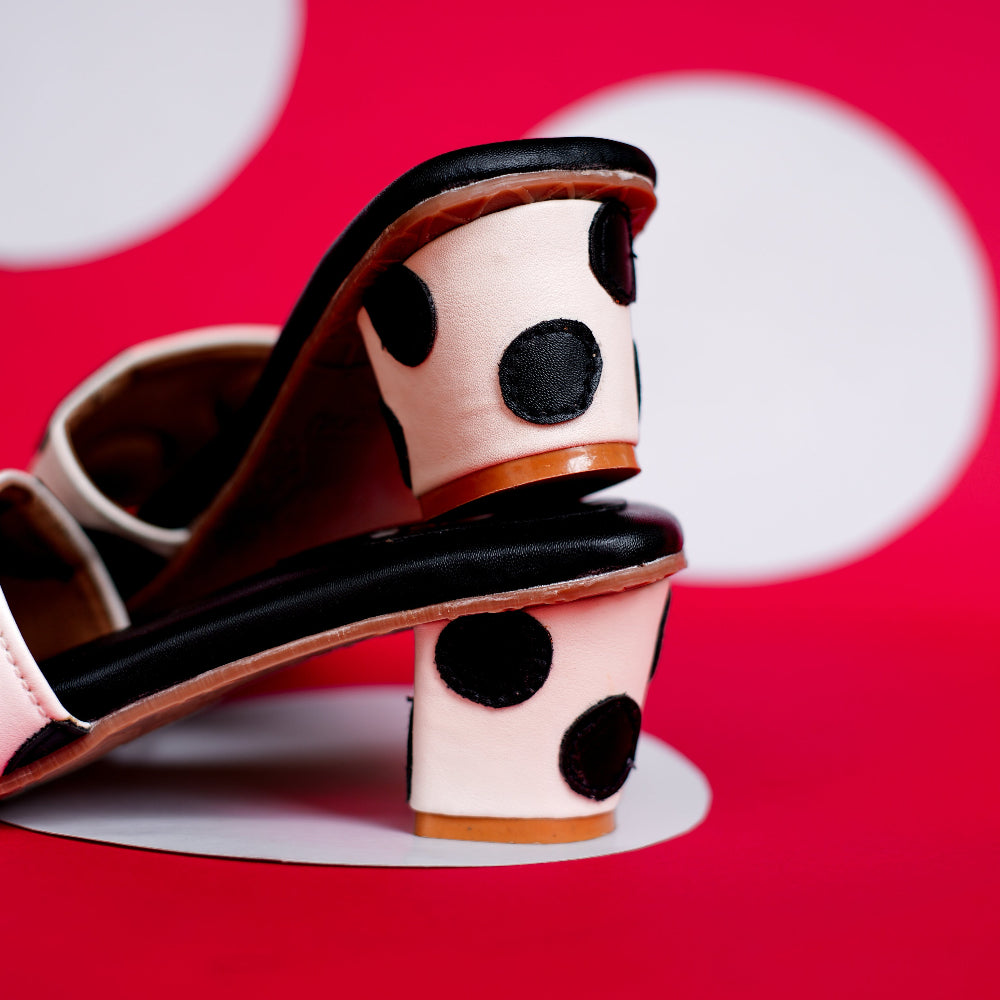 Black footbed mule with ivory strap and contrasting dot pattern