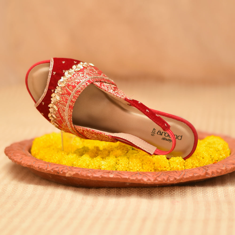 Ethnic red heel with intricate gold motifs and cushioned base
