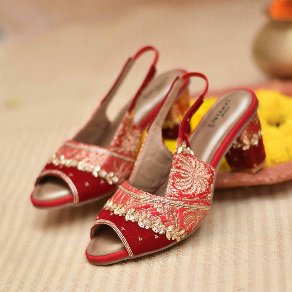 Red embroidered shoes with gold detailing and cushioned insole