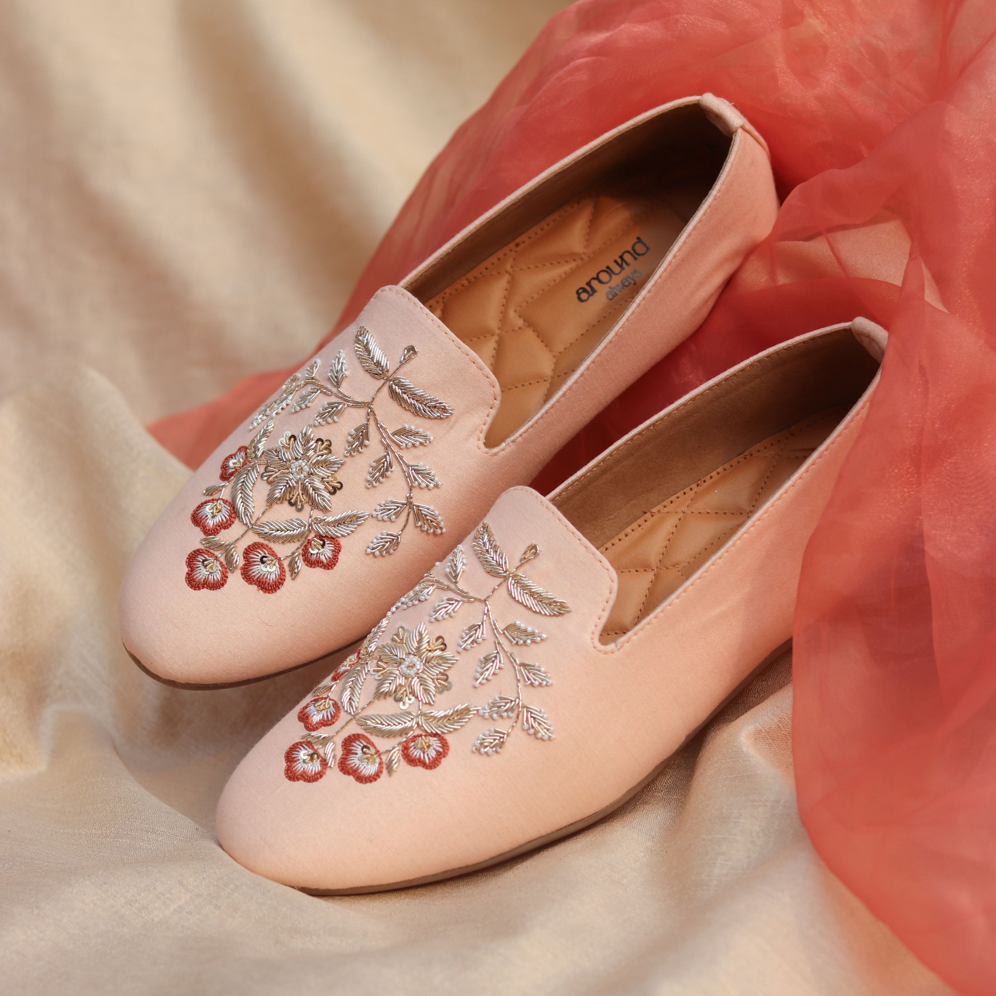 Stylish embroidered slip-on shoes blending delicate colors and traditional motifs for shaadi and parties.