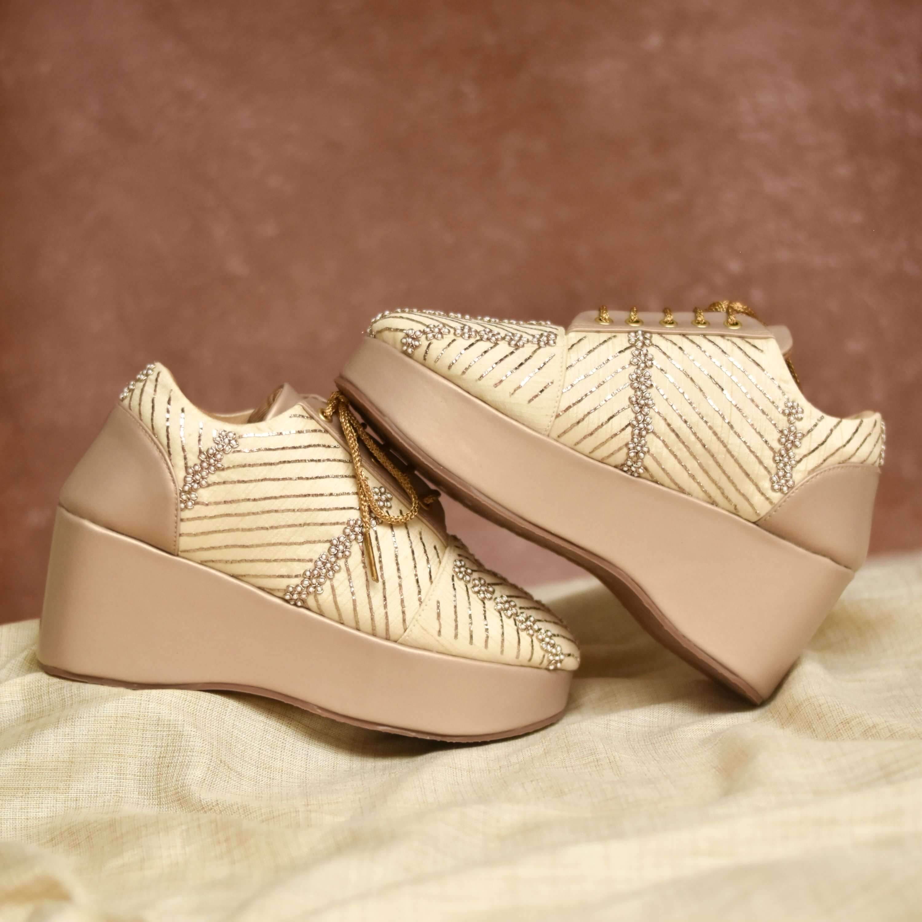 Designer gold heels with scattered bead sparkle and cushioned nude base